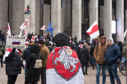 Minsk/ Belarus - 12/16/2019: in front of the palace of the republic, a protest rally against the integration of Russia and Belarus took place, poster with a crossed Russian flag