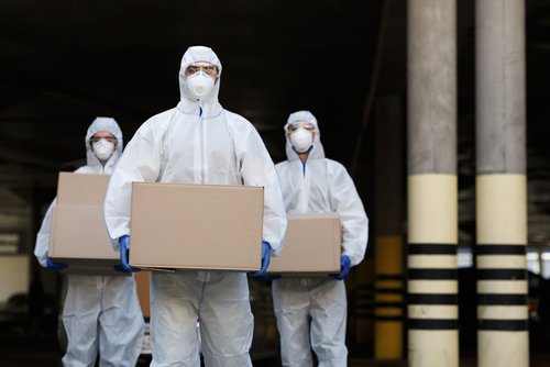 People in protective suits and masks delivering vaccine of coronavirus to population