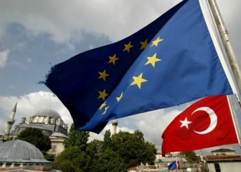 Turkish and EU flags are seen in front a mosque in Istanbul, Turkey 04 October 2005.