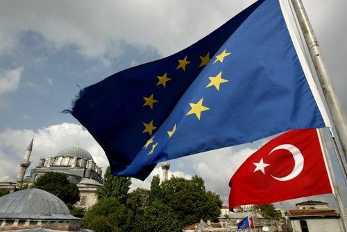 Turkish and EU flags are seen in front a mosque in Istanbul, Turkey 04 October 2005.