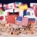 American flag in front of a wall and flags of other countries