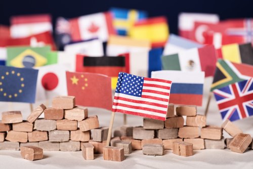 American flag in front of a wall and flags of other countries