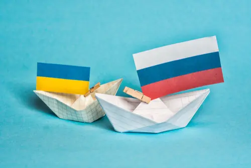 paper ships with flags of Ukraine and Russia, symbol of conflict