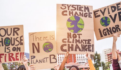 Group of demonstrators on road, young people from different culture and race fight for climate change - Global warming and enviroment concept - Focus on banners