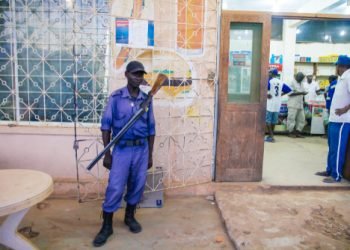 Montepuez, Mozambique-2016-12-05: African guard standing to secure in front of the store at Montepuez, Mozambique