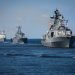 A line ahead of modern russian military naval battleships warships in the row, northern fleet and baltic sea fleet, summer sunny day