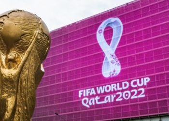 4 September 2019, Moscow, Russia. Copy of world cup trophy on background logo of the FIFA world Cup 2022, which will be held in Qatar, on a giant screen in the city center.