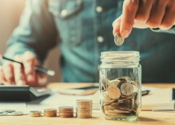 businessman holding coins putting in glass. concept saving money for finance accounting