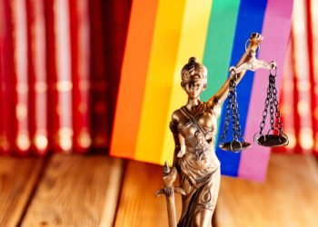 Statue of Justice - symbol of law and justice with lgbt flag. Lgbt rights and law