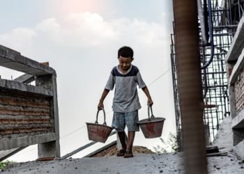 Children working at construction site for world day against child labor concept: