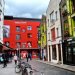 Dublin, Ireland -08-07-2015: Colorful street of Dublin. The Irish Rock 'n' Roll Museum Experience in the background. The Wall is Dublin's tribute to Irish musicians and a photography exhibition.