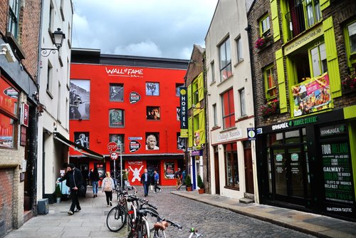 Dublin, Ireland -08-07-2015: Colorful street of Dublin. The Irish Rock 'n' Roll Museum Experience in the background. The Wall is Dublin's tribute to Irish musicians and a photography exhibition.