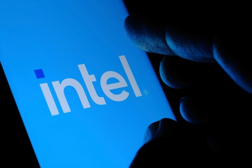 Stone UK - September 2 2020: New Intel logo seen on the screen and blurred fingertip touching it in a dark. Intel presented its rebranded logotype on September 2nd 2020. Selective focus.