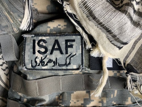 SAINT PETERS, MISSOURI - December 1, 2020: An ISAF Forces patch is affixed to a digital camouflage body armor. ISAF's role in Afghanistan began in 2001 and they are still active today.