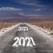 Long hard stony way concept, climate change target: view on endless dirt road through dry desert with numbers of years 2021, 2022, 2023