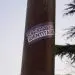Albi, France - Feb. 2021 - A blue and white sticker from Génération Identitaire, a right-wing youth movement opposing the migratory invasion and the Islamization of Europe, pasted on a lamp post pole