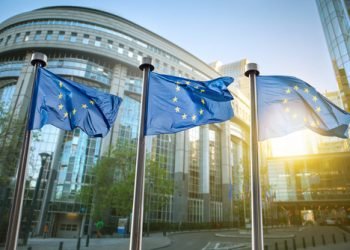 European union flag against parliament in Brussels, Belgium