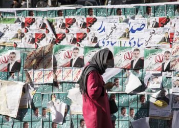 Iran's Parliamentary Election / Tehran , Iran - 21 February 2016 : Persian girl passing by posters of candidates of parliamentary election