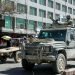 Kabul / Afghanistan - Aug 17 2005: A soldier mans a machine gun on the roof of an ISAF vehicle in Kabul, Afghanistan. Local people carry on with life. Guns, soldier, war, street, Kabul, Afghanistan.