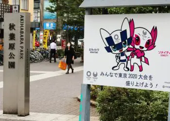 TOKYO, JAPAN - June 30, 2021: A sign promoting the Tokyo Olympics and Paralympics featuring their mascots Miraitowa and Someity in a park in Tokyo's Akihabara area.