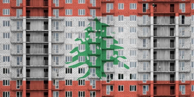 Lebanon flag depicted in paint colors on multi-storey residental building under construction. Textured banner on big brick wall background