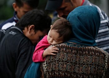 A,Family,Of,Refugees,Rest,In,Victoria,Square,,Where,Migrants