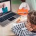 Pretty stylish schoolgirl studying homework math during her online lesson at home, social distance during quarantine, self-isolation, online education concept, home schooler