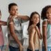 Cheerful,Vaccinated,Kids,Showing,Arms,After,Covid-19,Vaccination,Smiling,To