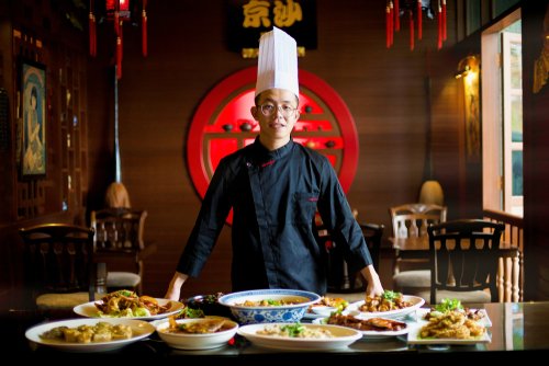 Young,Asian,Chef,Displaying,His,Special,Traditional,Gourmet,On,The