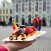 Belgium,Waffle,With,Chocolate,Sauce,And,Strawberries,,Bruges,City,Background,