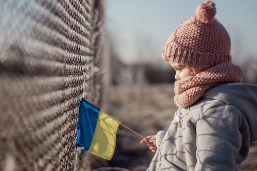 Girl,Holding,Ukrainian,Flag,,Asking,For,Peace,,Children,Against,War,