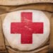 Medical,Aid,Symbol,On,A,Vintage,Jute,Army,Bag