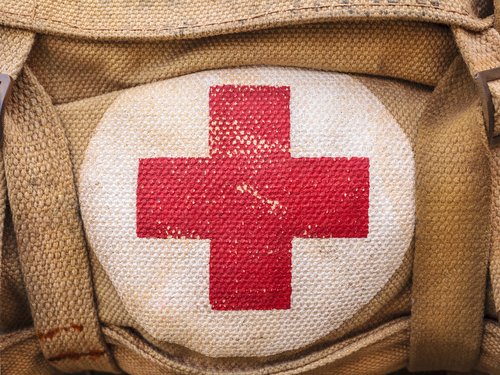 Medical,Aid,Symbol,On,A,Vintage,Jute,Army,Bag