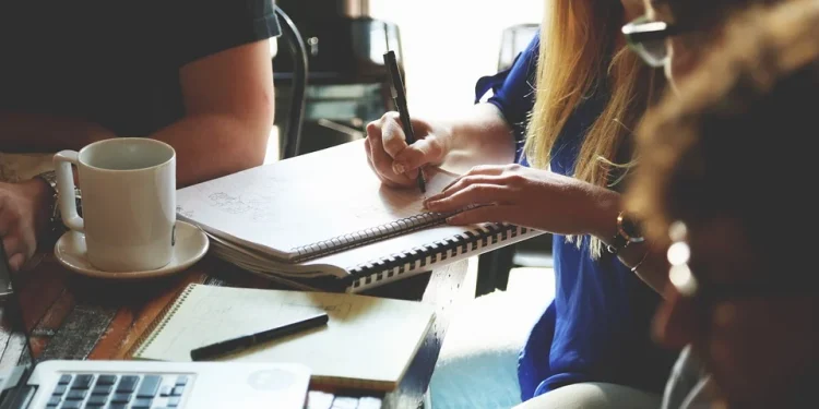 a office woman writing down something on notebook