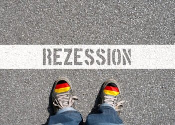 Man,,Shoes,With,German,Flag,And,German,Translation,For,Recession