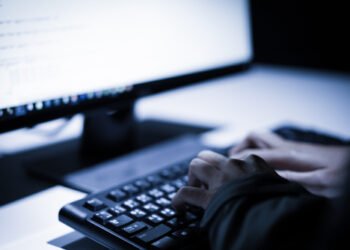 Hooded,Computer,Hacker,Stealing,Information,With,Laptop