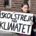 STOCKHOLM, SWEDEN - MARCH 22, 2019: 16-year-old Swedish climate activist Greta Thunberg demonstrating in Stockholm on Fridays. Holding a sign that says "School strike for Climate".