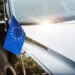 selective focus of european union flag near black shiny car