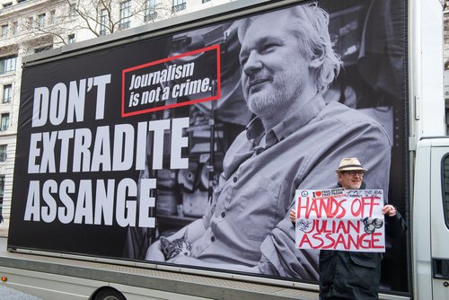 London, UK. 22nd February 2020. Protester with banner at the Don't Extradite Assange rally at Australia House in The Strand, in protest of WikiLeaks founder Julian Assange's extradition to the USA.