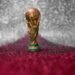 Vitória, Espírito Santo, Brazil - February 03, 2022 - Copy of world cup trophy on background red, white and silver, qatar flag's color