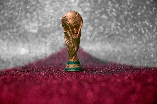 Vitória, Espírito Santo, Brazil - February 03, 2022 - Copy of world cup trophy on background red, white and silver, qatar flag's color