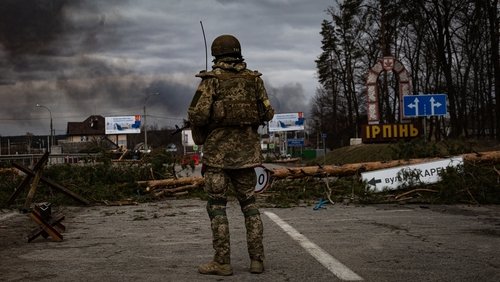 Irpin, Ukraine - 5 March 2022: Ukrainian soldier stands on the check point to the city Irpin near Kyiv during the evacuation of local people under the shelling of the Russian troops.