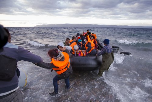 Lesvos island, Greece - 29 October 2015. Syrian migrants / refugees arrive from Turkey on boat through sea with cold water near Molyvos, Lesbos on an overload dinghy. Leaving Syria that has war