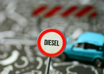 A,Car,And,A,Road,Sign,Indicating,Diesel,Driving,Ban