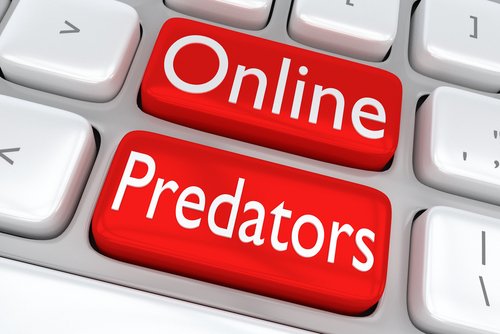 3D illustration of computer keyboard with the print "Online Predators" on two adjacent red buttons