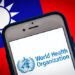 Kumamoto, JAPAN - May 24 2021 : The logo of WHO (The World Health Organization) on smartphone screen on Taiwanese flag bg. Taiwan is not yet invited to WHO despite Coronavirus success