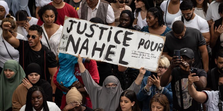 NANTERRE, FRANCE - JUNE 29:  29: Crowds protest during a memorial march for French teenager, Nahel, who was killed by police on June 29, 2023 in Nanterre, France. A French teenager of North African origin was shot dead by police on June 27th, the third fatal traffic stop shooting this year in France - causing nationwide unrest and clashes with police forces. On June 28th, the victim's family called for a memorial march starting at Nanterre's main police station on June 29th. (Photo by Abdulmonam Eassa/Getty Images)