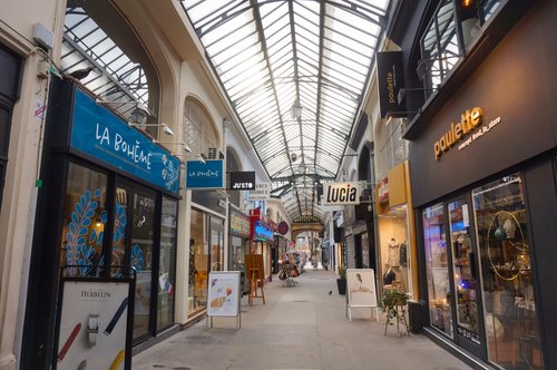 Reims, France - March 2021 - The covered passageway of Subé-Talleyrand, which consists in a shopping street in downtown covered with a glass awning, and bordered by various small local businesses