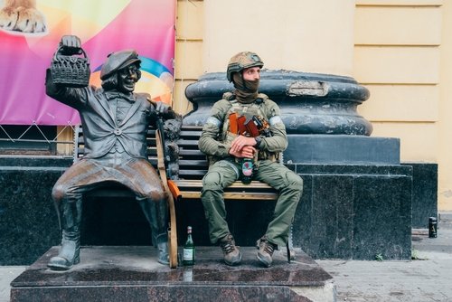 Russia, Rostov-on-Don, 24.06.2023. a soldier on a bench with a sculpture of a clown at a circus in Rostov-on-Don during the attempted military coup in Russia.