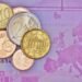 Euro coins on a banknote